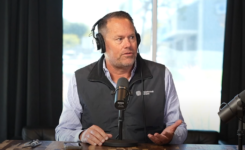 Mike Rankin sitting in front of a microphone in a podcast studio.