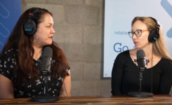 Vannessa Ruiz and Kristin Conti sitting in front of microphones in a podcast studio.